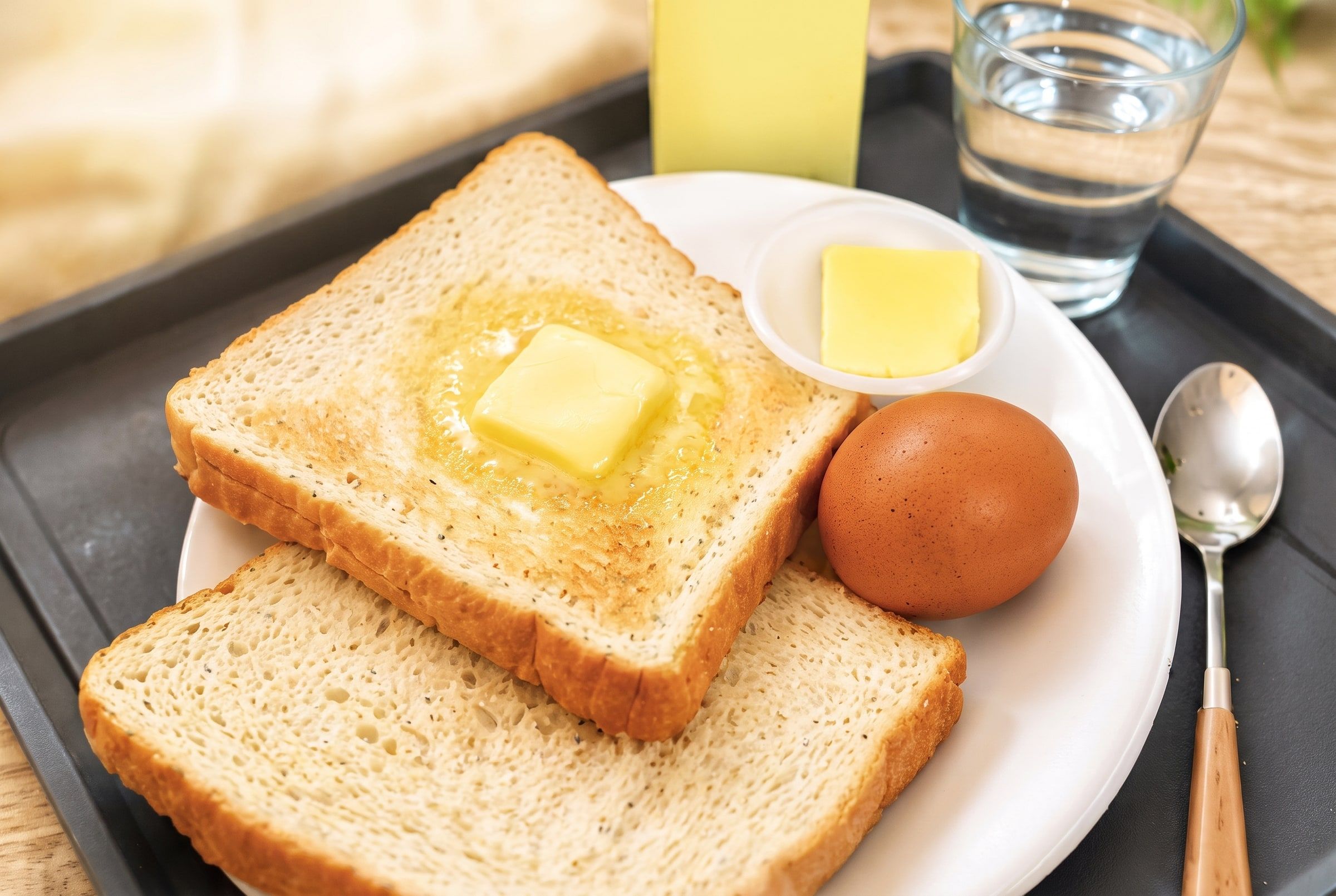 Nutritious breakfast — bread, butter, egg and soy milk