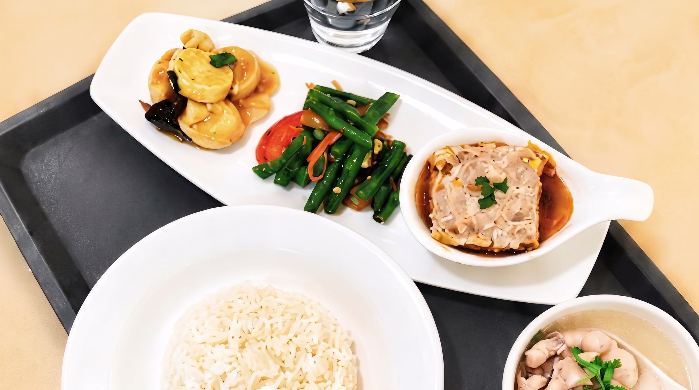 Balanced meal tray with rice, soup and dishes — cooked with less salt